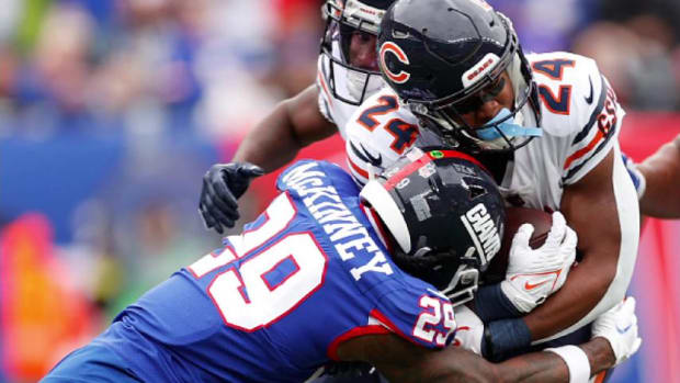 Safety Xavier McKinney of the Giants makes a tackle of Khalil Herbert. The physical free safety will be facing the Bears as he signed with Green Bay.